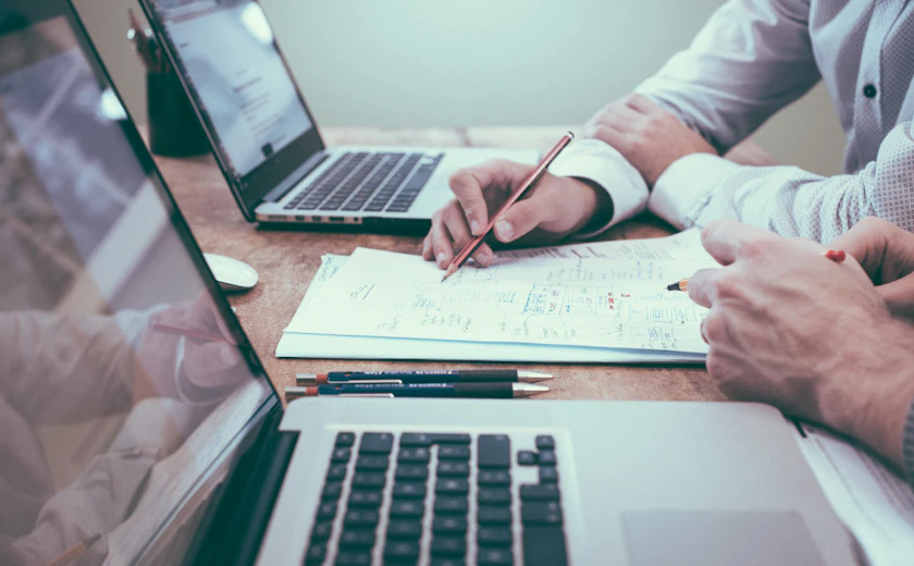 Reviewing documents and reports together at a desk